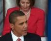 President Obama reacting to the passage of the House Bill while House Speaker Nancy Pelosi stands in the background.