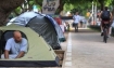 Young Israelis seen near tents set up on Rothschild Avenue in Tel Aviv are pressing the Israeli government to find a solution to the soaring cost of housing