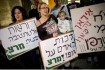 Jewish mother and Israeli Intactivist Elinor holds a sign that reads 