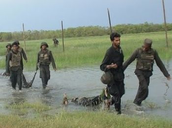 Sri Lankan government forces drag corpses of Tamil Tigers.