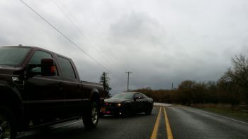 Police car stopping car near flood zone