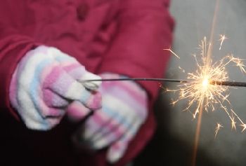 child holding sparkler