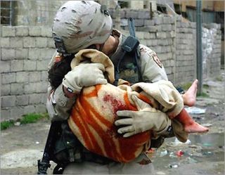 US soldier carrying wounded child in Mideast