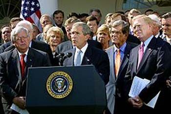 President George W. Bush, surrounded by leaders of the House and Senate, announces the Iraq war resolution on October 2, 2002.