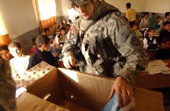 U.S. soldier gives out school supplies to kids