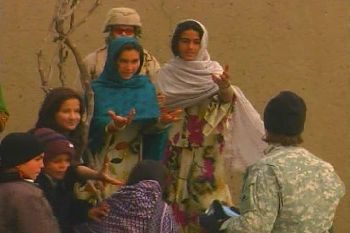 Afghan women desperately ask an American soldier to provide medical supplies in Kabul.  Salem-News.com photo by Tim King